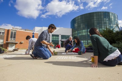Students chalking sidewalks at School of Fine Arts, 2012